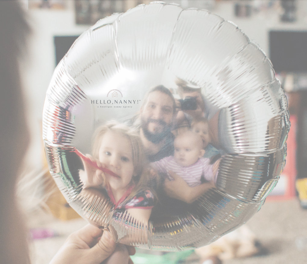 family looking at reflection in balloon